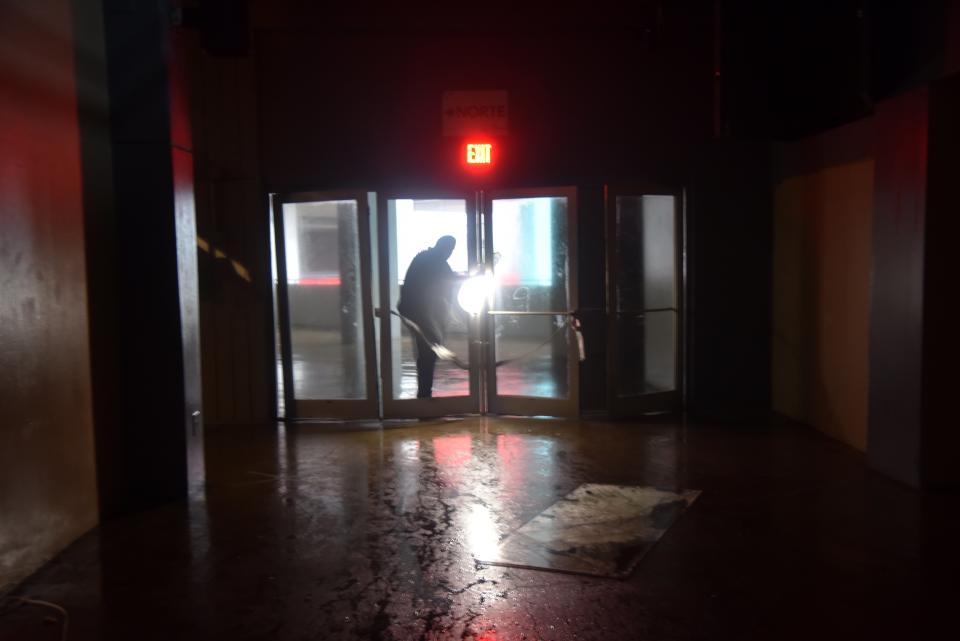 <p>A man passes through a door at Roberto Clemente Coliseum in San Juan, Puerto Rico, which suffered damages from wind on September 20, 2017, during the passage of the Hurricane Maria. (Photo: Hector Retamal/AFP/Getty Images) </p>