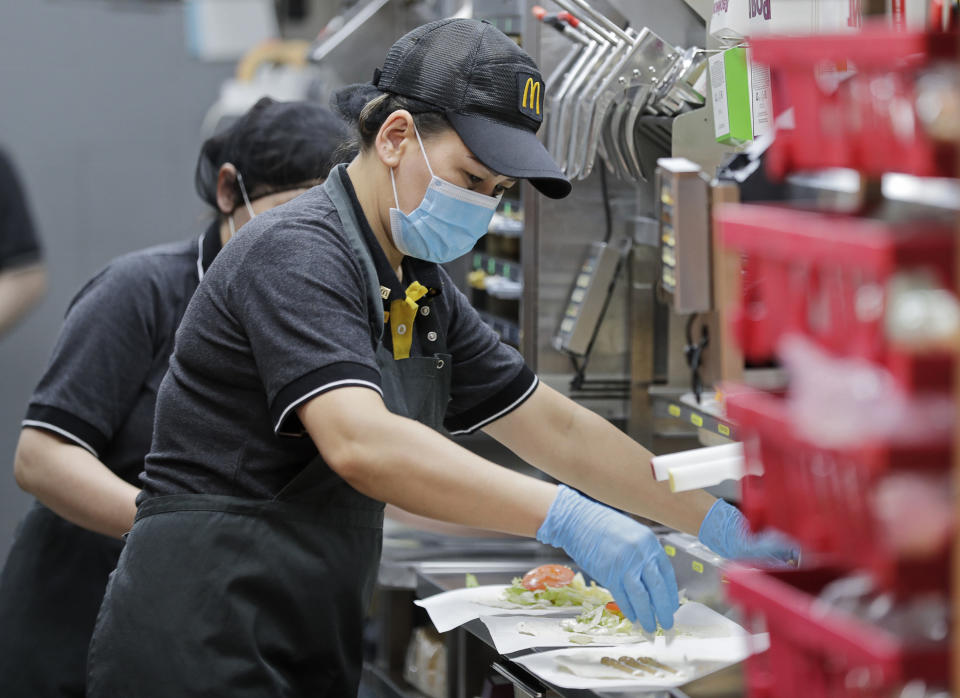 Fast food worker preparing food in a McDonald's