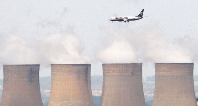 FILE PHOTO: File photograph shows a Ryanair aircraft flying above Ratcliffe Power Station as it comes into land at East Midlands Airport in central England