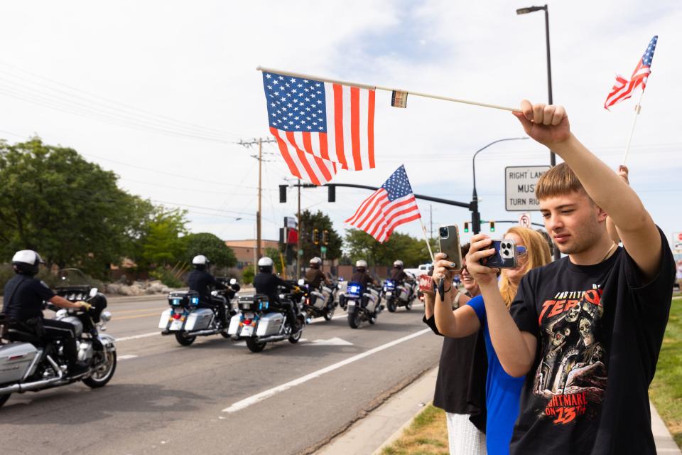 Michael Furgis watches with his mom Susanne Gustin as the presidential motorcade drives out of the Roland R. Wright Air National Guard Base in Salt Lake City on Wednesday, Aug. 9, 2023. | Megan Nielsen, Deseret News