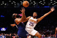 Brooklyn Nets guard James Harden, left, draws a foul against Phoenix Suns forward Mikal Bridges (25) during the first half of an NBA basketball game, Saturday, Nov. 27, 2021, in New York. (AP Photo/Jessie Alcheh)