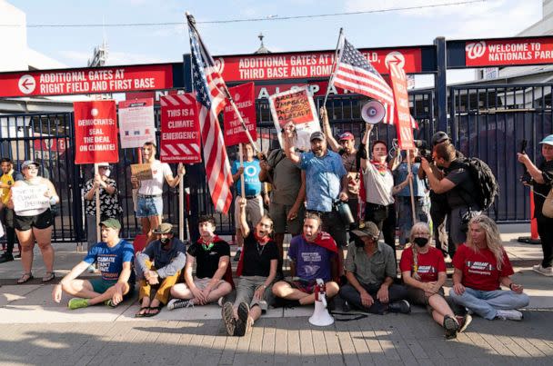 PHOTO: Climate activists protest outside Nationals Park, where the annual Congressional Baseball Game for Charity is being held in Washington, July 28, 2022. (Jose Luis Magana/AP)