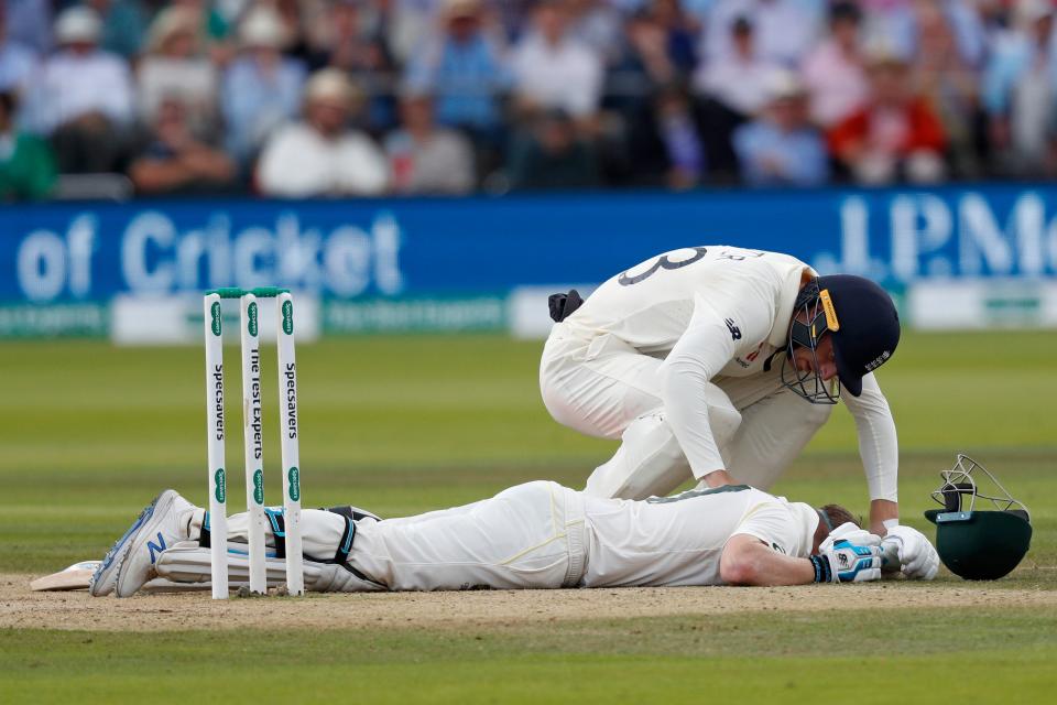 TOPSHOT - England's Jos Buttler shows concern for Australia's Steve Smith as he falls to the pitch after being hit on the neck by a ball off the bowling of England's Jofra Archer (unseen) during play on the fourth day of the second Ashes cricket Test match between England and Australia at Lord's Cricket Ground in London on August 17, 2019. (Photo by Adrian DENNIS / AFP) / RESTRICTED TO EDITORIAL USE. NO ASSOCIATION WITH DIRECT COMPETITOR OF SPONSOR, PARTNER, OR SUPPLIER OF THE ECB        (Photo credit should read ADRIAN DENNIS/AFP/Getty Images)