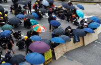 Demonstrators take cover during a protest in Hong Kong