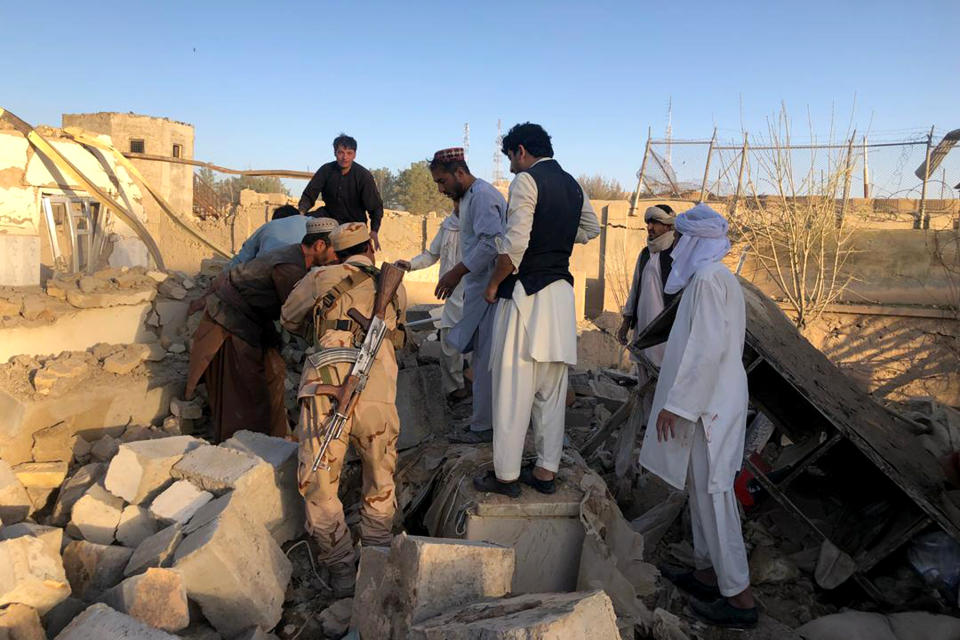 Afghan security members and people work at the site of a suicide attack in Zabul, Afghanistan, Thursday, Sept. 19, 2019. A powerful early morning suicide truck bomb devastated a hospital in southern Afghanistan on Thursday. (AP Photo/Ahmad Wali Sarhadi)