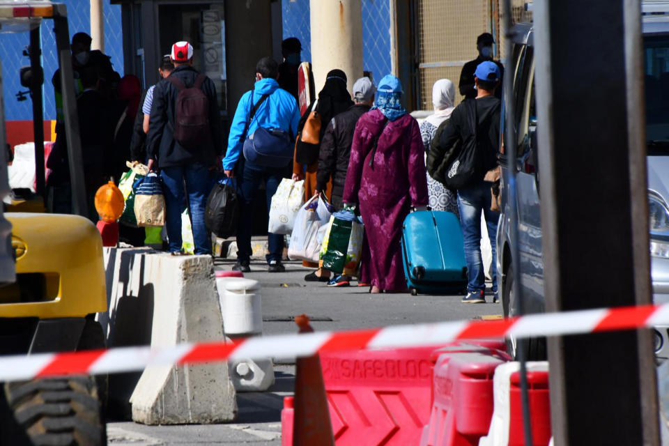 In this Friday, May 22, 2020, photo, Moroccan citizens wait for repatriation after being stranded in Spain due to the coronavirus pandemic in the Spanish enclave of Ceuta, Spain. (Faro de Ceuta via AP)