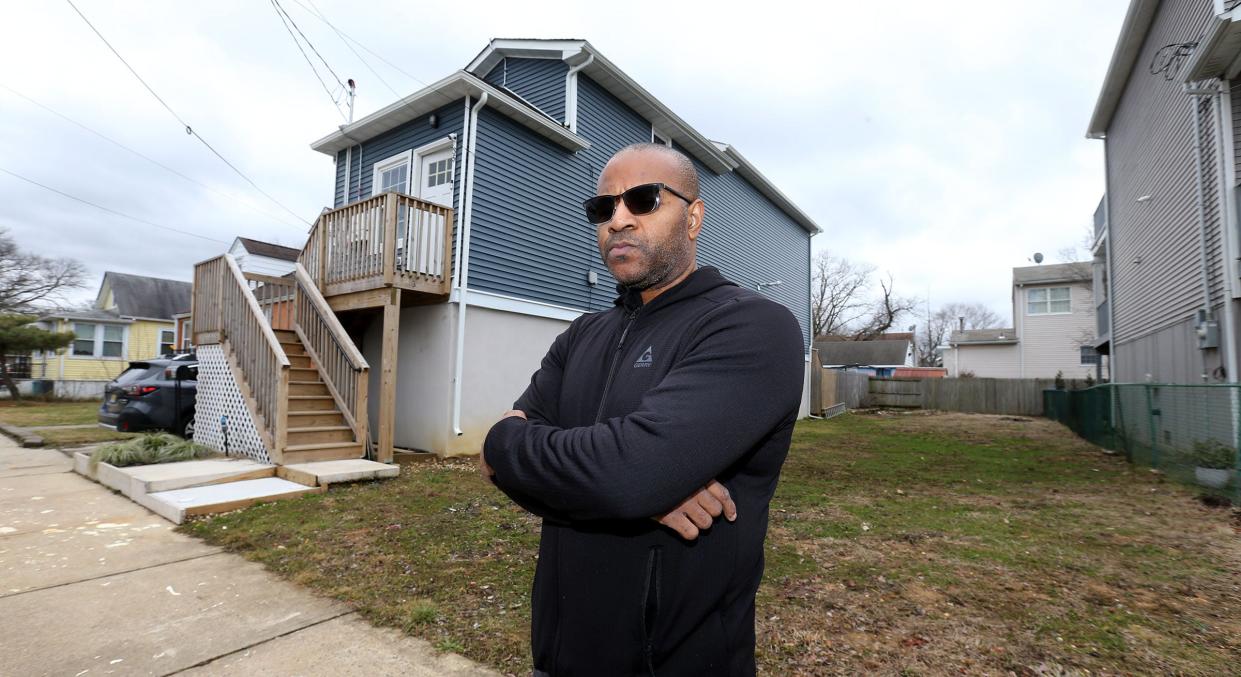 Landlord David Wellington stands in front of his empty property at 33 Myrtle Avenue and completed home at 35 Myrtle Avenue in Keansburg Wednesday, January 31, 2024. He owns both properties and is in a dispute with the borough over construction and renovation there.