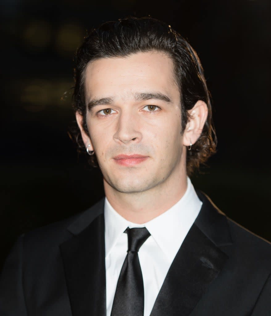 Matty in suit and tie with neatly styled hair at an event