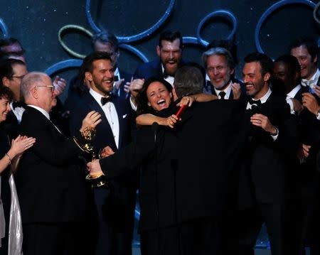 Executive Producer David Mandel embraces lead actress Julia Louis-Dreyfus as he celebrates the award for Outstanding Comedy Series for "Veep" along with the cast and crew at the 68th Primetime Emmy Awards in Los Angeles, California, U.S., September 18, 2016. REUTERS/Mike Blake