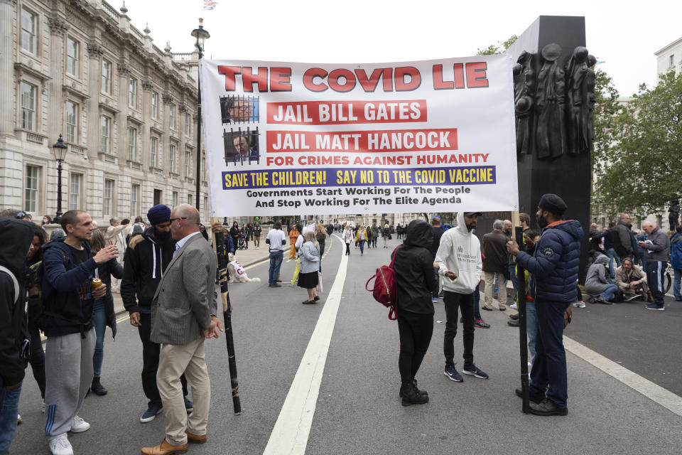 Protesters holding a banner march towards Westminster from Trafalgar Square