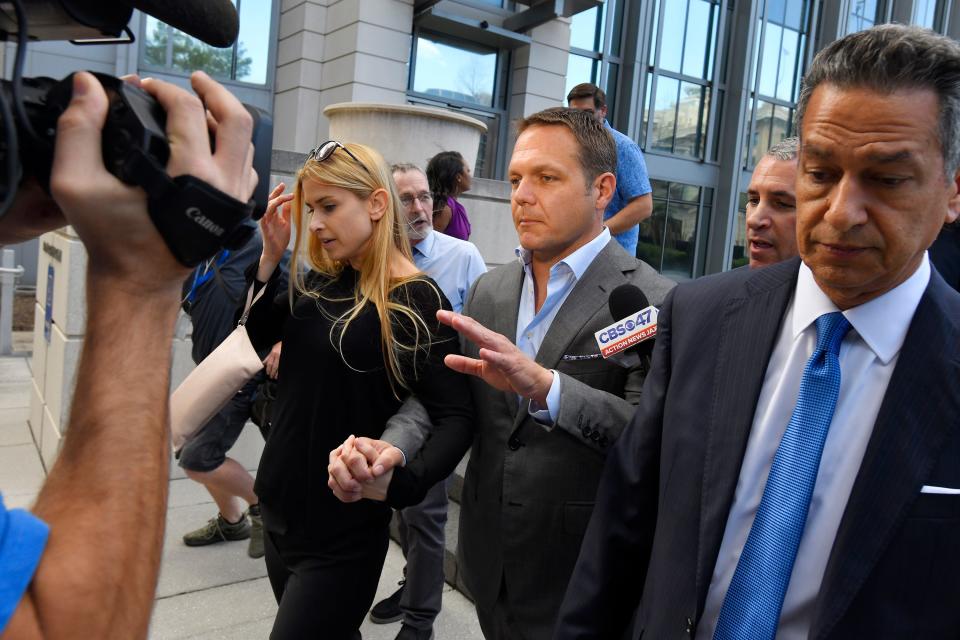 Former JEA CEO Aaron Zahn with his wife Mary Branan Ennis Zahn and attorney Brian Albritton leaves the Federal Courthouse after Zahn posted bond on March 8, 2022.