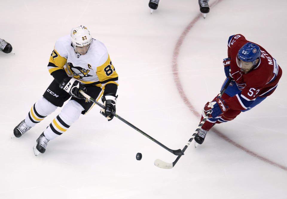 Montreal Canadiens defenseman Victor Mete (53) clears the puck from Pittsburgh Penguins center Sidney Crosby (87) during the first period of an NHL hockey playoff game Friday, Aug. 7, 2020, in Toronto. (Frank Gunn/The Canadian Press via AP)