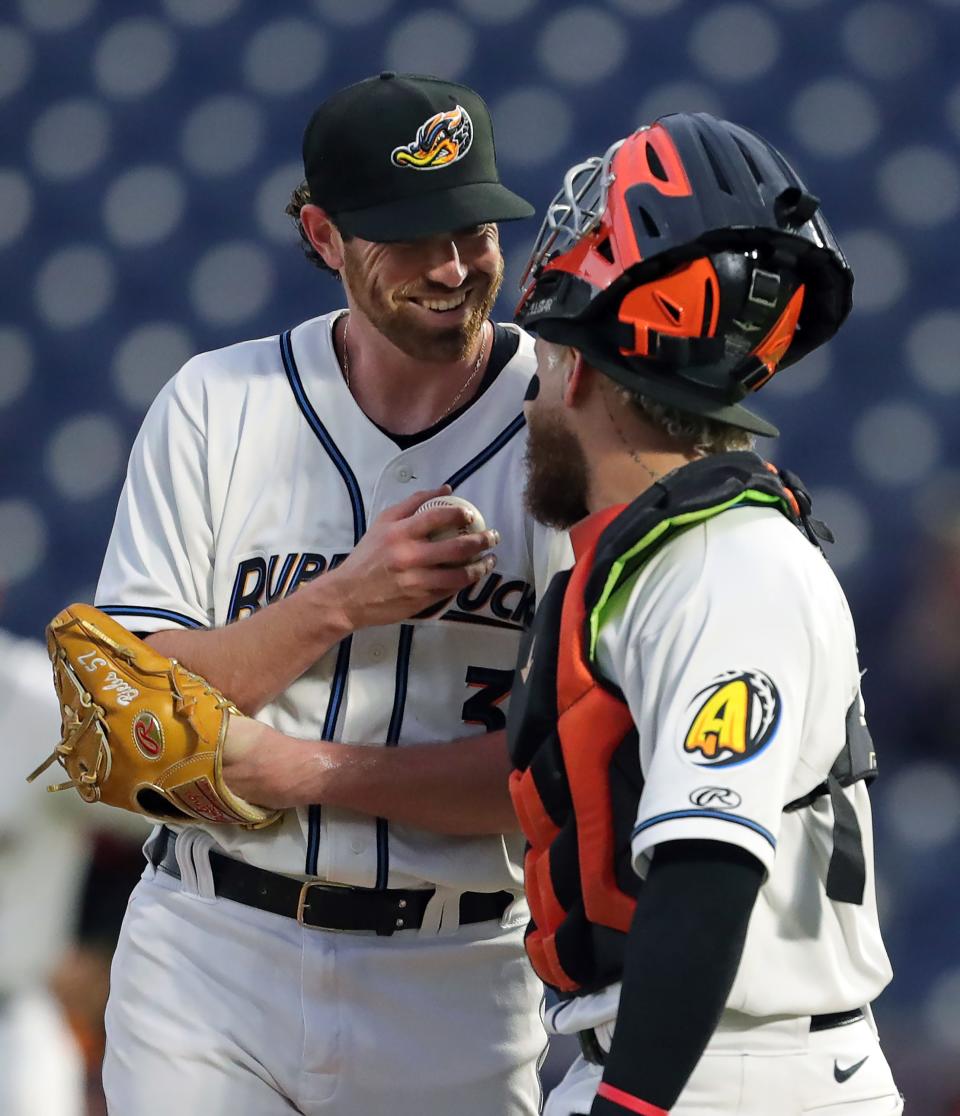 Cleveland Guardians pitcher Shane Bieber, left, meets with Akron RubberDucks catcher Micael Ramirez during the fourth inning of a minor league game Sept. 12 against the Altoona Curve in Akron.