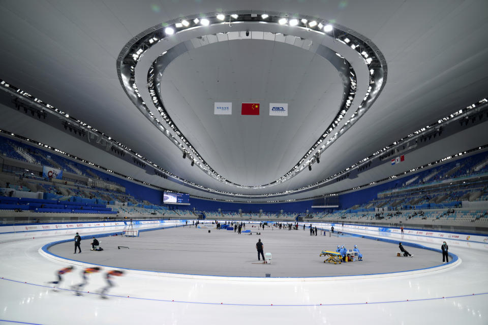 Skaters compete during the Speed Skating China Open, a test event for the 2022 Winter Olympics, at the National Speed Skating Oval in Beijing, Saturday, Oct. 9, 2021. The venue will host speed skating competition at the upcoming 2022 Beijing Winter Olympics. (AP Photo/Mark Schiefelbein)