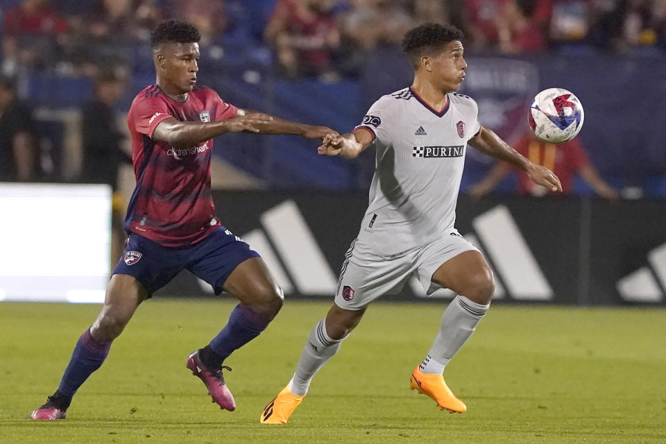 Sporting Kansas City forward Khiry Shelton, right, and FC Dallas forward Jader Obrian vie for control of the ball during the first half of an MLS soccer match Saturday, May 6, 2023, in Frisco, Texas. (AP Photo/LM Otero)