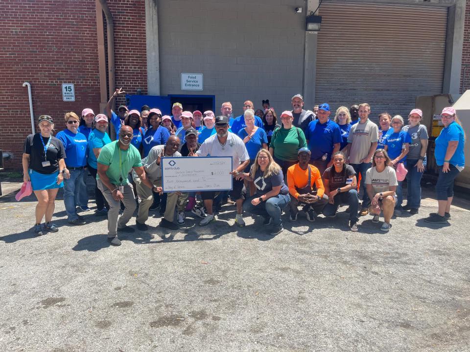 Volunteers from Jacksonville-area Sam's Club and two local organizations, the Donovin Darius Foundation and B.O.L.D. Endeavors, pose for a group photo at a work service day at Sulzbacher, a nonprofit that serves the homeless.