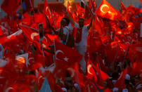 <p>People wave Turkey’s national flags as they attend a ceremony marking the first anniversary of the attempted coup at the Bosphorus Bridge in Istanbul, Turkey July 15, 2017. (Photo: Murad Sezer/Reuters) </p>