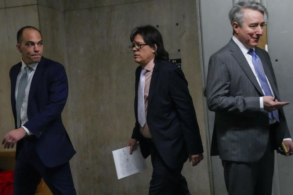 Memorabilia seller Edward Kosinski, center, and Former Rock & Roll Hall of Fame curator Craig Inciardi are seen in the hallway of the supreme court, Wednesday, Feb. 21, 2024, in New York. A criminal case involving handwritten lyrics to the classic rock megahit “Hotel California” and other Eagles favorites went to trial Wednesday in New York, with three men accused of scheming to thwart band co-founder Don Henley’s efforts to reclaim the allegedly ill-gotten documents. (AP Photo/Mary Altaffer)