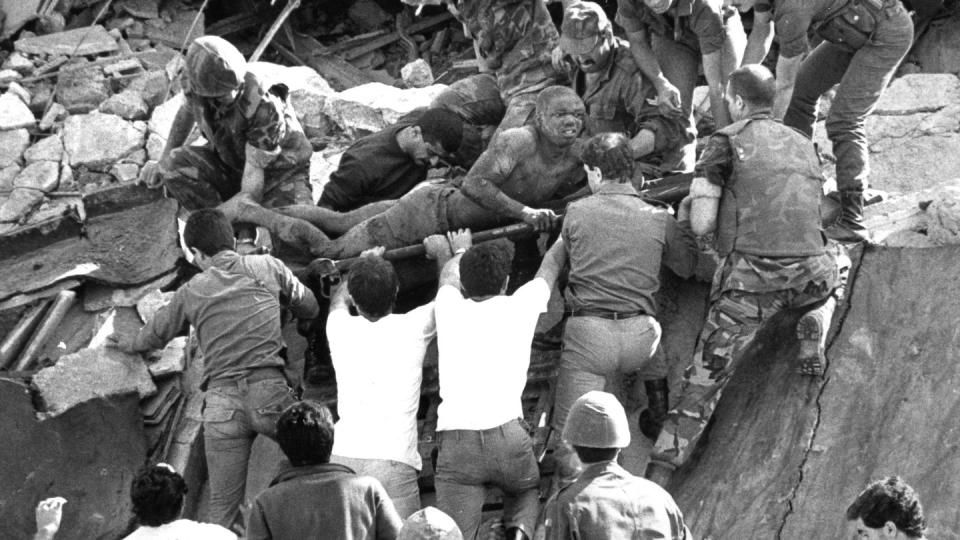 In this Oct. 23, 1983 file photo, British soldiers give a hand in rescue operations at the site of the bomb-wrecked U.S. Marine command center near the Beirut airport, Lebanon. A bomb-laden truck drove into the center collapsing the entire four story building. (Bill Foley, File/The Associated Press)