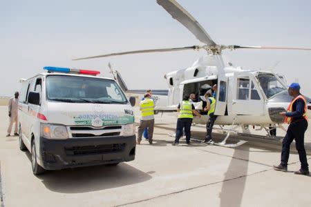 UNHAS members evacuate bodies of three aid workers, who were killed during an attack in the town of Rann, at Maiduguri Airport, Nigeria March 2, 2018. OCHA/Yasmina Guerda Handout via REUTERS