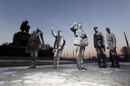 Members of the campaigning community Avaaz placed life-size cardboards, depicting Benito Mussolini, Adolf Hitler, Josef Stalin, Francisco Franko and Philippe Petain in front of the Kaiser Wilhelm monument at the Deutsches Eck ("German Corner") to protest against a European far-right leaders meeting, in Koblenz, Germany, January 21, 2017. REUTERS/Kai Pfaffenbach