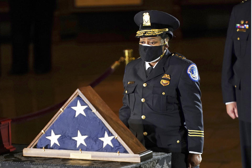 In this Feb. 2, 2021 file photo, acting U.S. Capitol Police Chief Yogananda Pittman pays respects to U.S. Capitol Police officer Brian Sicknick in the Capitol Rotunda in Washington. (Erin Schaff/The New York Times via AP, Pool)