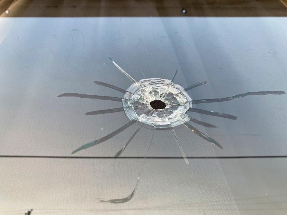 A bullet hole is visible in the glass transom over the door at the Mahogany Masterpiece dance studio in Dadeville, Ala., on April 16, 2023