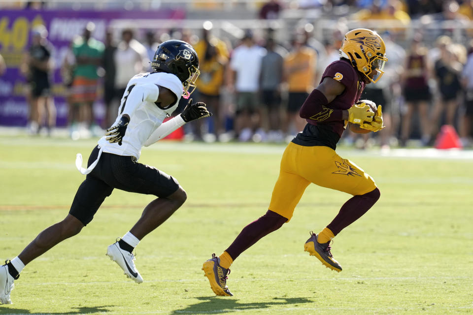 Arizona State wide receiver Elijhah Badger, right, runs with the ball past Colorado cornerback Cormani McClain, left, during the first half of an NCAA college football game Saturday, Oct. 7, 2023, in Tempe, Ariz. (AP Photo/Ross D. Franklin)