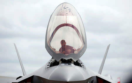 A ground crew member works in the cockpit of a U.S. Marine Corps Lockheed Martin F-35B fighter jet at the Royal International Air Tattoo at Fairford, Britain July 8, 2016. REUTERS/Peter Nicholls