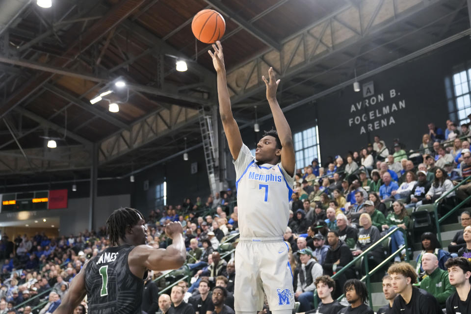 Memphis forward Nae'Qwan Tomlin (7) shoots over Tulane guard Sion James (1) during the first half of an NCAA college basketball game in New Orleans, Sunday, Jan. 21, 2024. (AP Photo/Gerald Herbert)