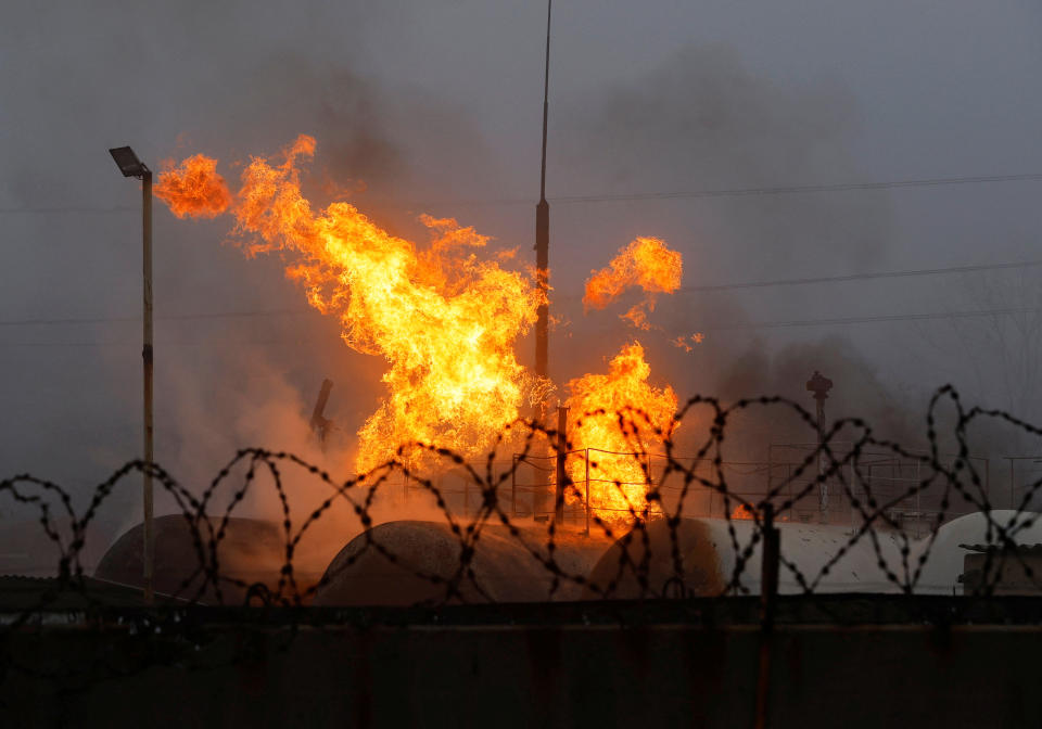 Fire burns at a fuel storage site after shelling in the course of Russia-Ukraine conflict in Makiivka (Makeyevka), Russian-controlled Ukraine, November 21, 2022. REUTERS/Alexander Ermochenko