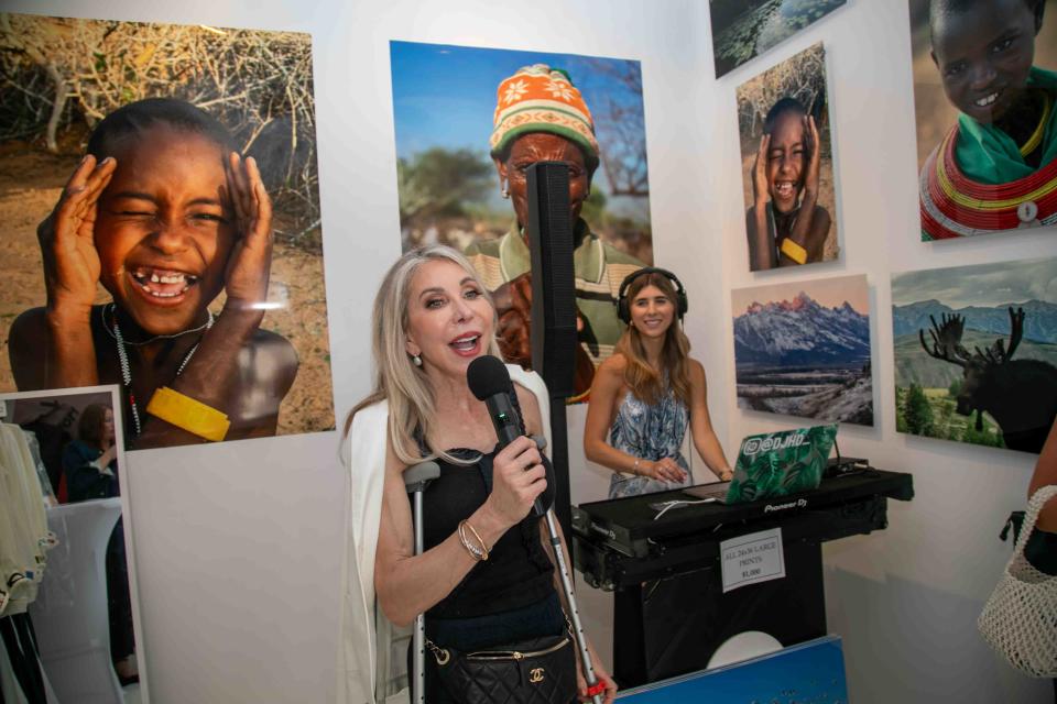 Oditto Gallery founder Celeste Jones makes remarks during the gallery's Art, Wine, Fashion Friday event March 15. At right is DJ Heather Desanti.