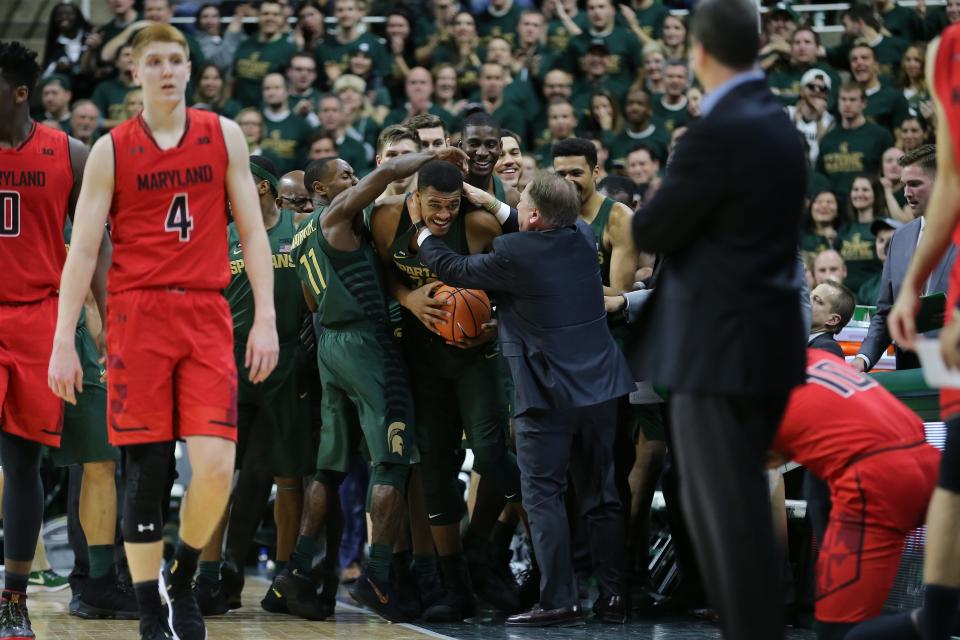 Michigan State coach Tom Izzo celebrates with Xavier Tillman, center, in the first half against Maryland at Breslin Center on Jan. 4, 2018 in East Lansing.