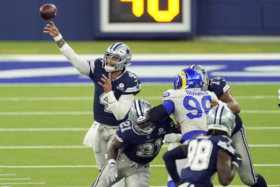 Dallas Cowboys quarterback Dak Prescott, left, throws behind a block by Ezekiel Elliott (21) during the second half of an NFL football game against the Los Angeles Rams Sunday, Sept. 13, 2020, in Inglewood, Calif. (AP Photo/Ashley Landis)