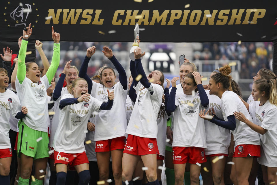 Washington Spirit players celebrate with the trophy after defeating Chicago Red Stars in the NWSL Championship soccer match, Saturday, Nov. 20, 2021, in Louisville, Ky. (AP Photo/Jeff Dean)