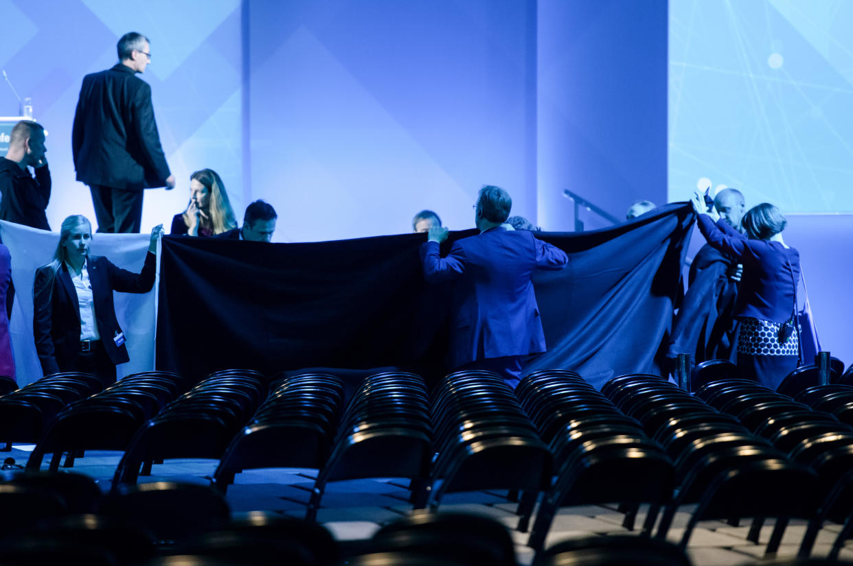 29 October 2019, North Rhine-Westphalia, Dortmund: Helpers shield the view to the stage with a blanket after Economics Minister Peter Altmaier (CDU) fell heavily at the digital summit. After his opening speech at the Digital Summit in Dortmund, Altmaier fell off the stage while walking. Photo: Bernd Thissen/dpa (Photo by Bernd Thissen/picture alliance via Getty Images)