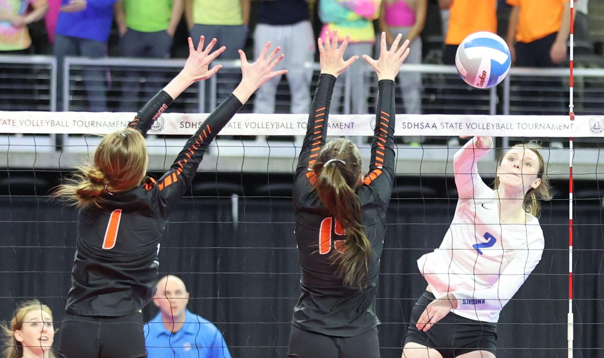 Sioux Falls O'Gorman's Bergen Reilly smacks the ball against two Huron defenders during their first-round Class AA match in the South Dakota State Volleyball Tournament on Thursday, Nov. 17, 2022 in the Denny Sanford PREMIER Center in Sioux Falls.