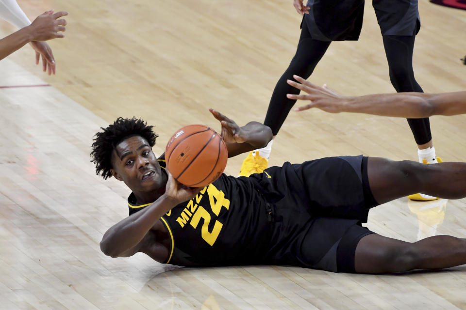 Missouri forward Kobe Brown (24) tries to pass the ball against Arkansas during the first half of an NCAA college basketball game in Fayetteville, Ark. Saturday, Jan. 2, 2021. (AP Photo/Michael Woods)