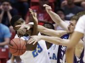 UCLA center Tony Parker, left, battles Stephen F. Austin forward Tanner Clayton for the loose ball during the first half of a third-round game in the NCAA college basketball tournament, Sunday, March 23, 2014, in San Diego. (AP Photo/Gregory Bull)