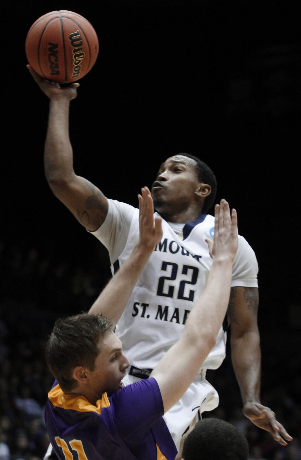 Mount St. Mary's guard Rashad Whack (22) shoots over Albany forward Luke Devlin in the first half of a first-round game of the NCAA college basketball tournament, Tuesday, March 18, 2014, in Dayton, Ohio. (AP Photo/Skip Peterson)