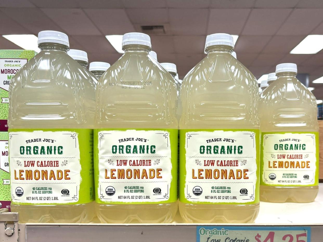 Bottles of Trader Joe's organic low-calorie lemonade on a shelf.