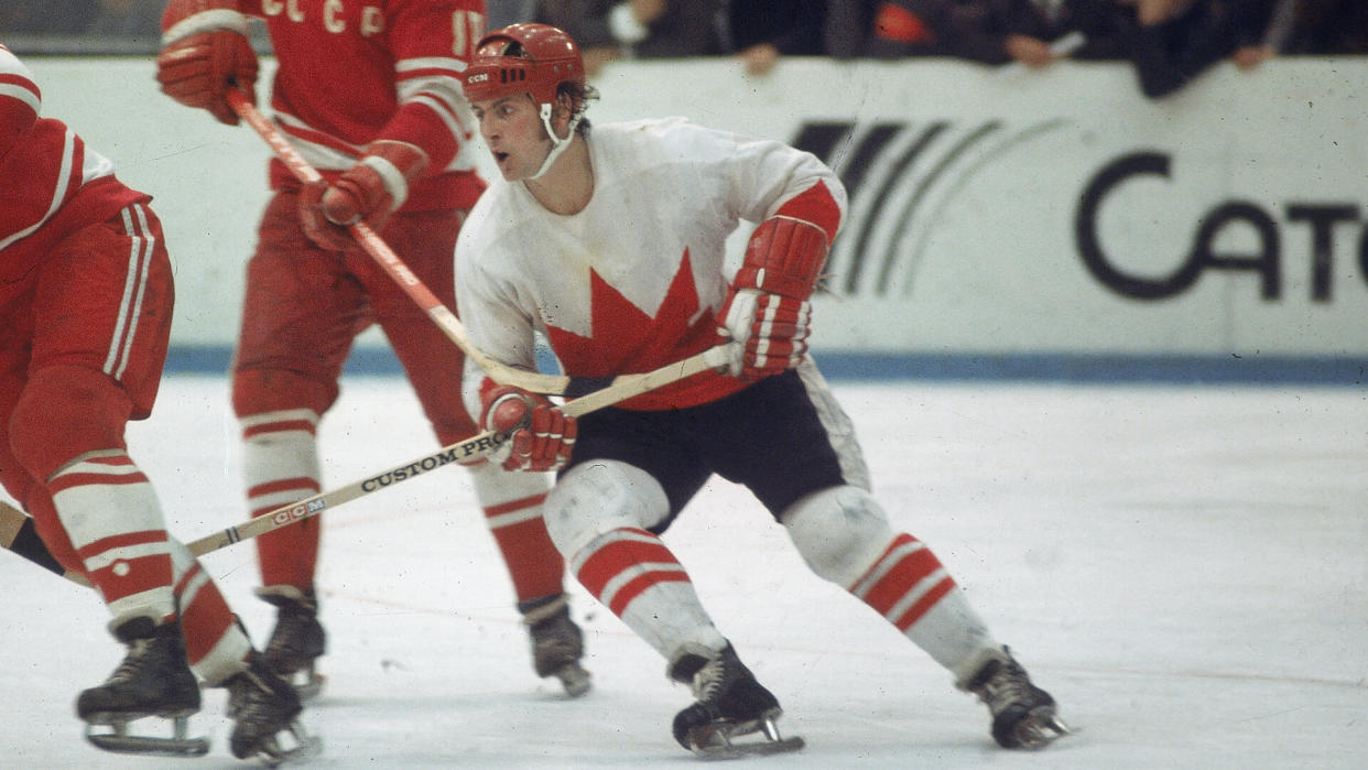 Canadian professional hockey player Paul Henderson (right), left wing for Team Canada, skates by two players from the Soviet team during a game from the Summit Series, 1972.