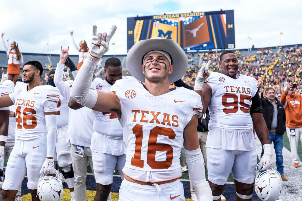 Texas safety Michael Taaffe and fellow Longhorns celebrate a 31-12 win over Michigan at Michigan Stadium in Ann Arbor on Saturday.