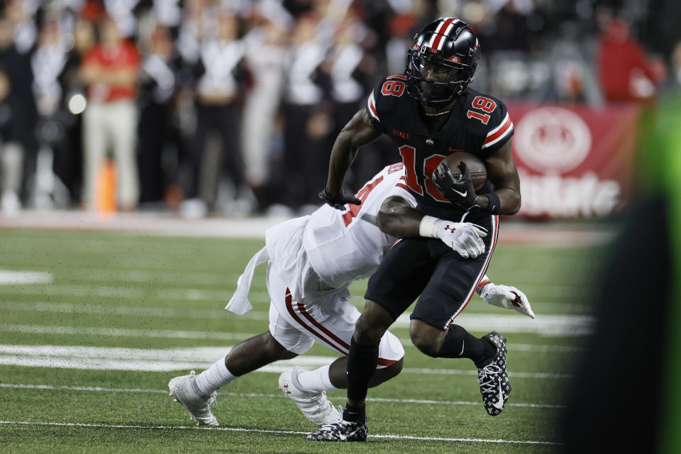 Ohio State receiver Marvin Harrison (18) tries to get away from Wisconsin linebacker Jordan Turner during the first half of an NCAA college football game Saturday, Sept. 24, 2022, in Columbus, Ohio. (AP Photo/Jay LaPrete)