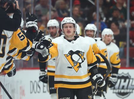 Jan 18, 2019; Glendale, AZ, USA; Pittsburgh Penguins center Jake Guentzel (59) celebrates with teammates after scoring a goal against the Arizona Coyotes in the second period at Gila River Arena. Mandatory Credit: Mark J. Rebilas-USA TODAY Sports