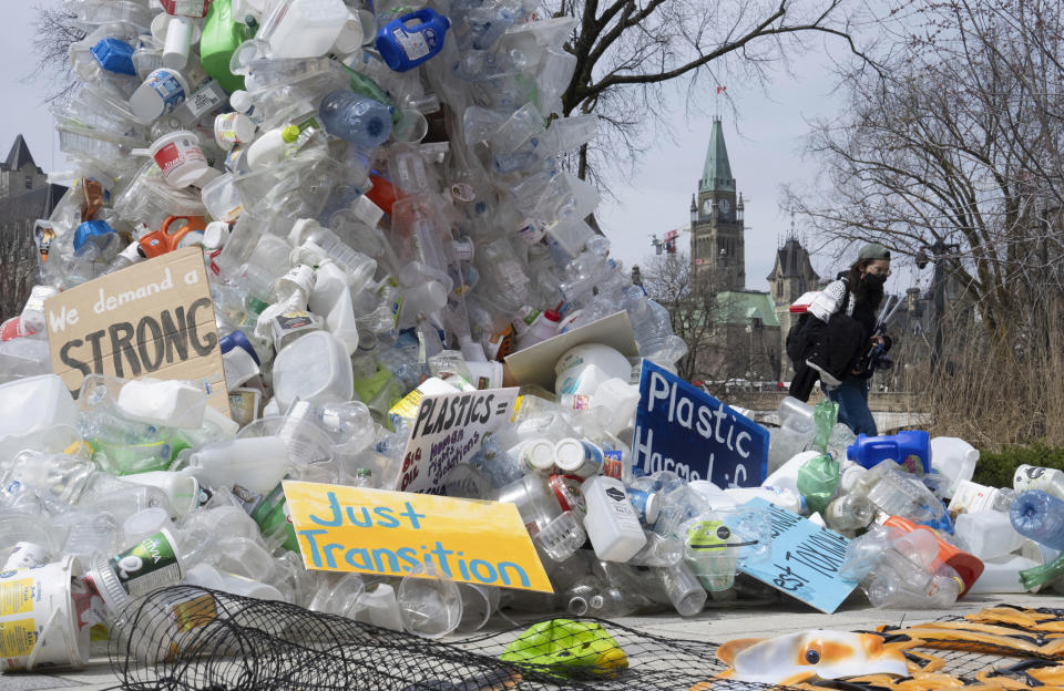 FILE - A person walks past an art installation outside a United Nations conference on plastics on April 23, 2024, in Ottawa, Ontario. (Adrian Wyld/The Canadian Press via AP, File)