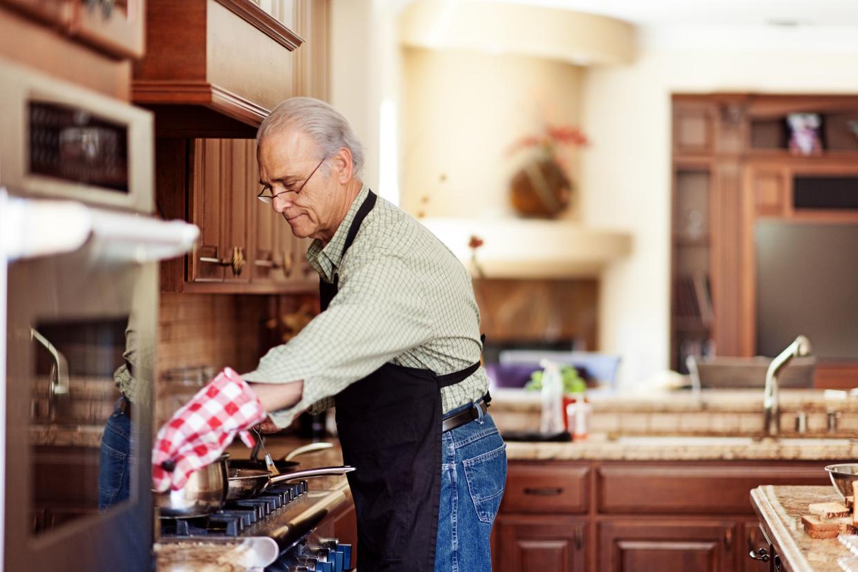 Single senior man cooking turkey