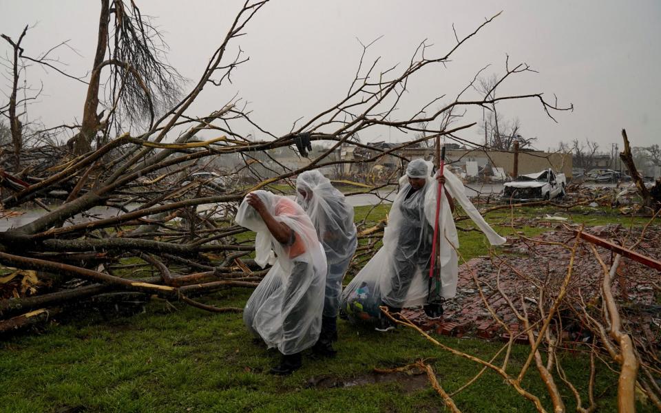 The McKnight family gather belongings from the wreckage of their home - REUTERS/Cheney Orr