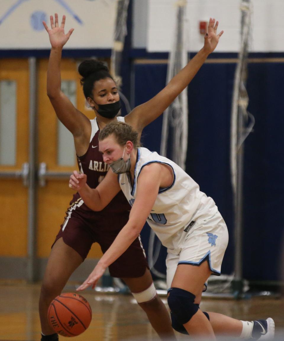 John Jay's Ashley Buragas is defended in the post by Arlington forward Maya Watts during a Jan. 19, 2022 girls basketball game.