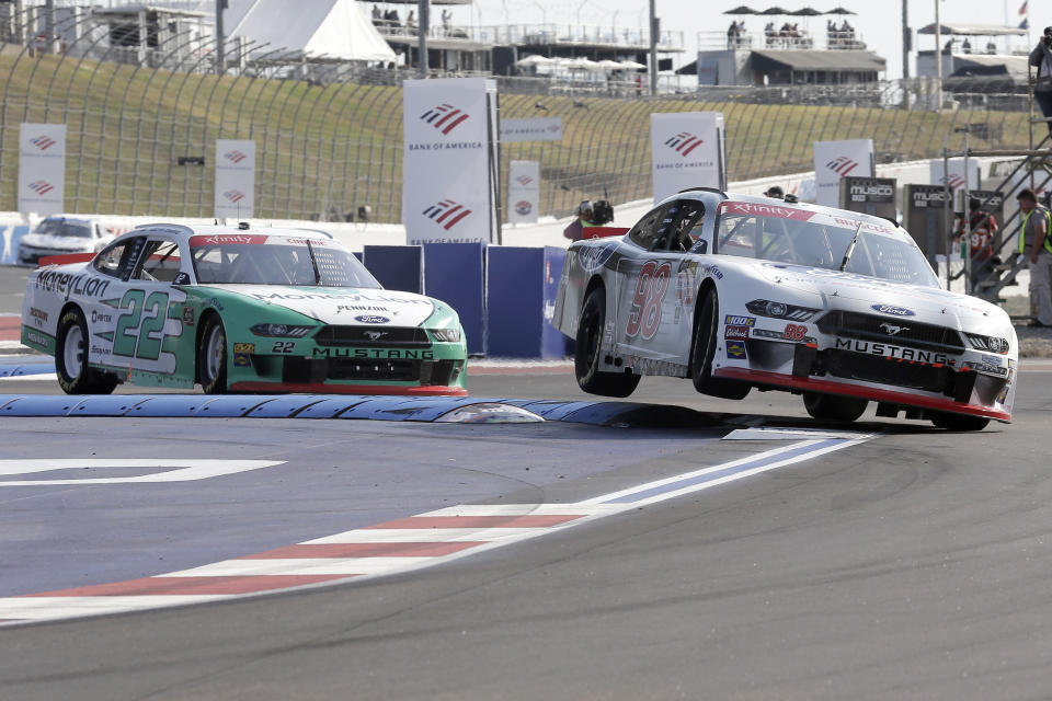 Chase Briscoe (98) leads Austin Cindric (22) into Turn 12 during the NASCAR Xfinity Series auto race at Charlotte Motor Speedway in Concord, N.C., Saturday, Sept. 28, 2019. (AP Photo/Gerry Broome)